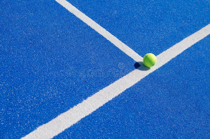 A Ball on the Baseline of a Paddle Tennis Court Racket Sports Concept A Ball on the Baseline of a Paddle Tennis Court Racket Sports Concept