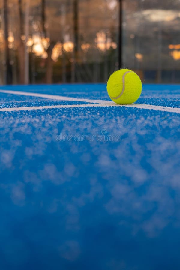 A Ball on the Baseline of a Paddle Tennis Court at Sunset Racket A Ball on the Baseline of a Paddle Tennis Court at Sunset Racket