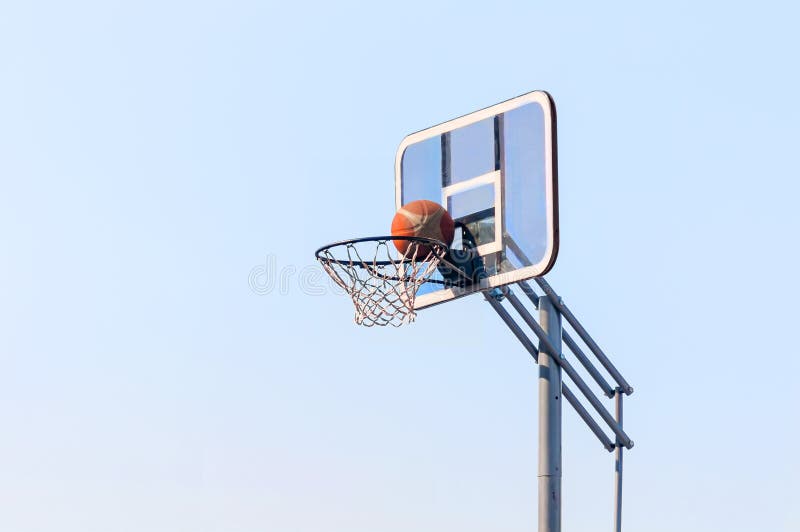 Ball into the basketball hoop