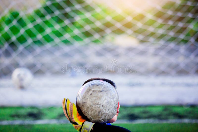 Ball in hand of goalkeeper stock photo. Image of kids 120451542