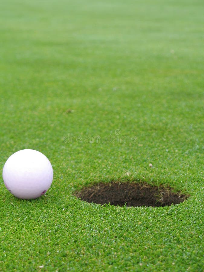 Ball beside hole