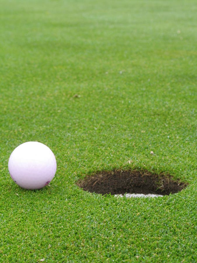 Ball beside hole