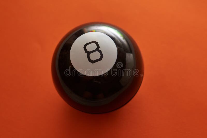 The Ball of Predictions Figure Eight on an Orange Background Stock