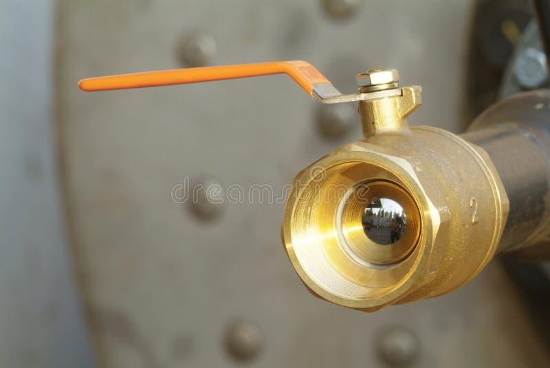 Ball valve with orange handle royalty free stock image