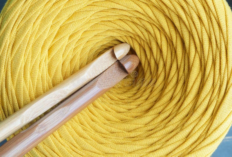 A Ball of Yellow Yarn Closeup and Crochet Hooks. the Concept of