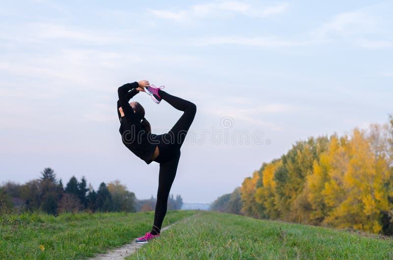 Beautiful ballerina dancing outdoor on sunny autumn day. Beautiful ballerina dancing outdoor on sunny autumn day.