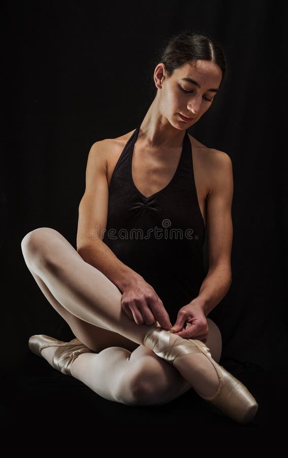 Ballerina preparing her ballet shoes