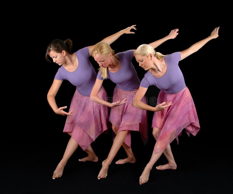 Ballerinas dancing together isolated over a black background