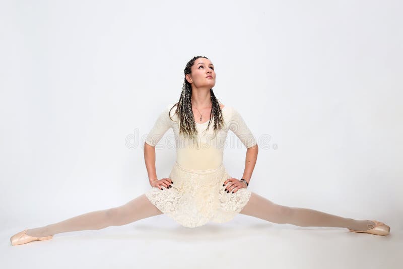 Beautiful, sexy blonde ballerina girl with afro braids posing in studio on isolated background.  Ballet, art, fashion concept.