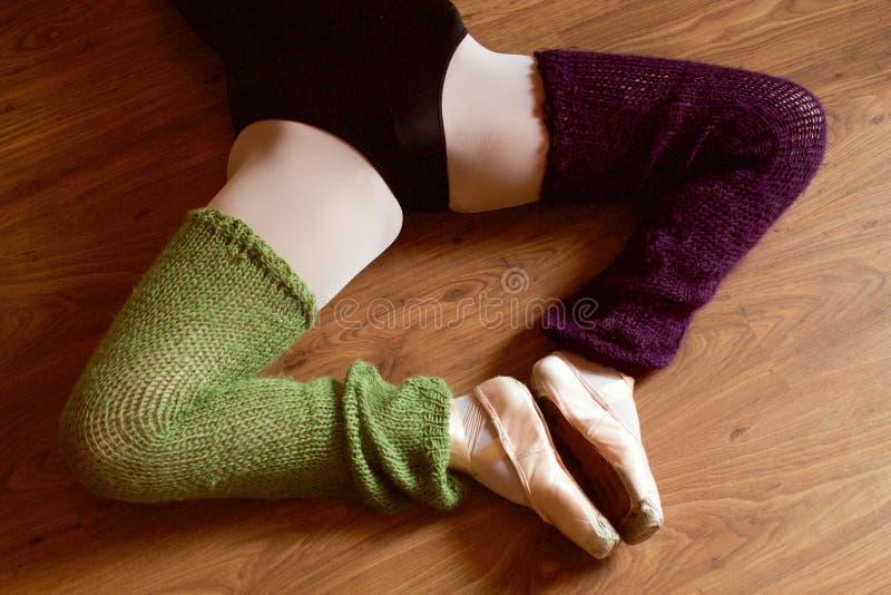 Ballet dancer legs with pointe shoes doing stretching rotation