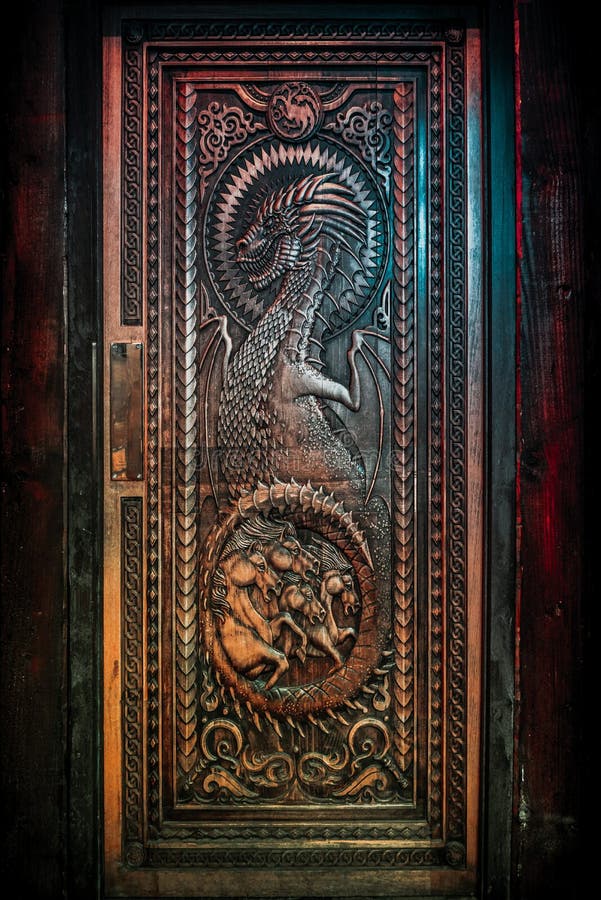 BALLINTOY HARBOUR, NORTHERN IRELAND, DECEMBER 20, 2018: Magnificent carved door with dragons and Dothraki horses, made with wood