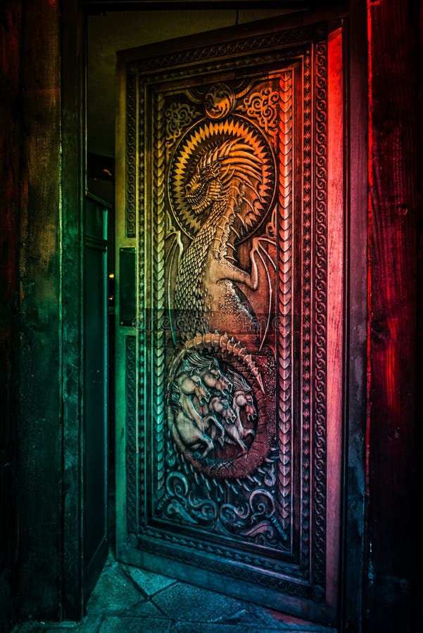 BALLINTOY HARBOUR, NORTHERN IRELAND, DECEMBER 20, 2018: Magnificent carved door with dragons and Dothraki horses, made with wood
