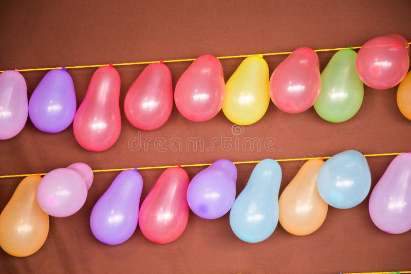 Balloon shooting game with balloons tied on a string - Stock Image -  Everypixel