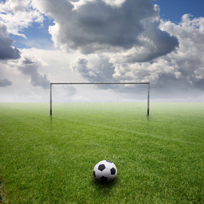 Its a football pitch, with grey clouds. Its a football pitch, with grey clouds