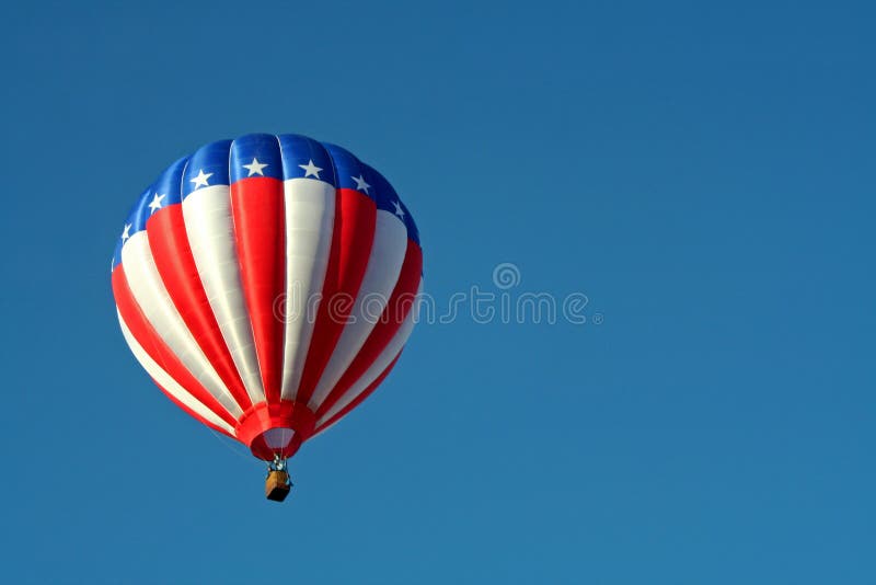 A red, white, and blue hot air balloon soars in a clear blue sky. A red, white, and blue hot air balloon soars in a clear blue sky.