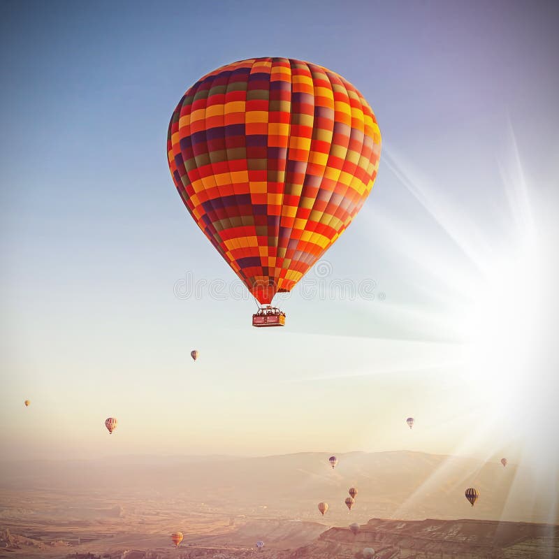 Balloons in the sky over Cappadocia at sunrise. Vintage retro style. Balloons in the sky over Cappadocia at sunrise. Vintage retro style