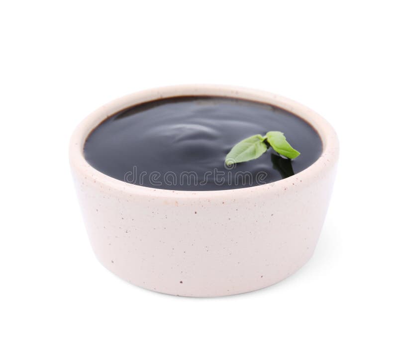 Balsamic Glaze with Basil Leaves in Bowl Isolated on White Stock Image