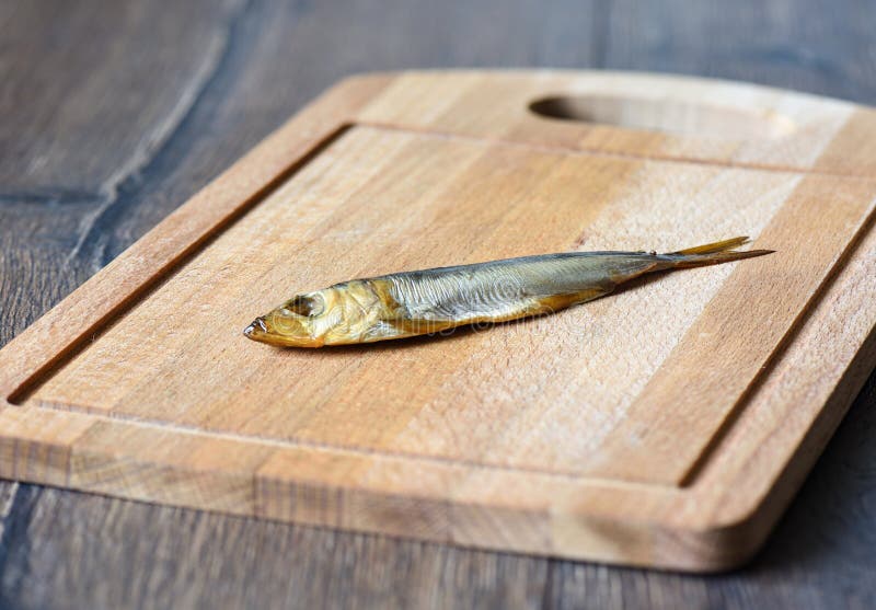 Baltic herring cold smoked on a wooden cutting board royalty free stock photos Baltic herring cold smoked on a wooden cutting board royalty free stock photos