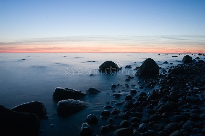 Baltic seaside with stones after sunset