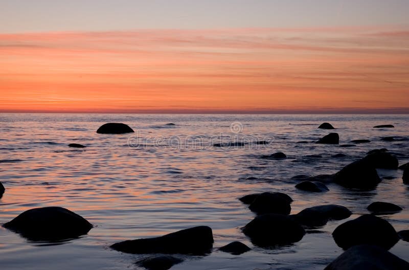 Baltic seaside with stones after sunset