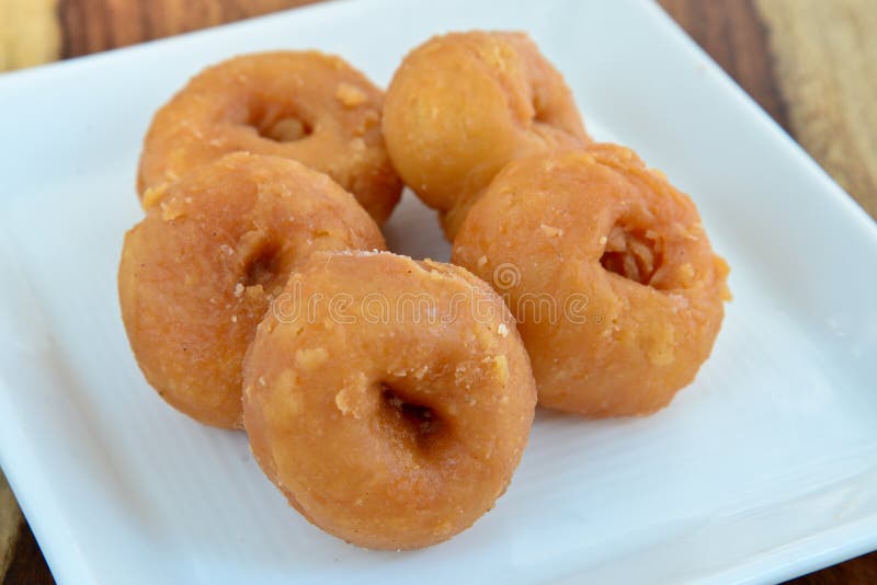 Balushahi is a traditional dessert in northern Indian Cuisine, Pakistani Cuisine and Nepali cuisine, similar to a glazed doughnut. In South India, a similar pastry is known as Badushah.