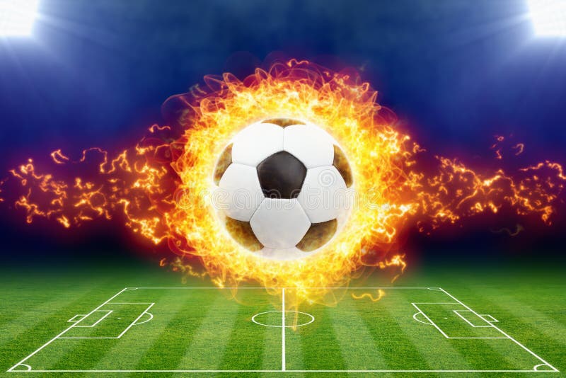 Balón de fútbol ardiente sobre el estadio de fútbol verde imagenes de archivo Balón de fútbol ardiente sobre el estadio de fútbol verde imagenes de archivo