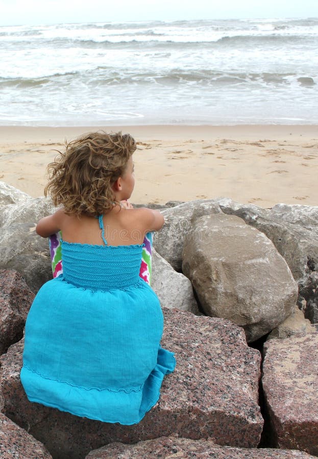 Bambina che esamina oceano