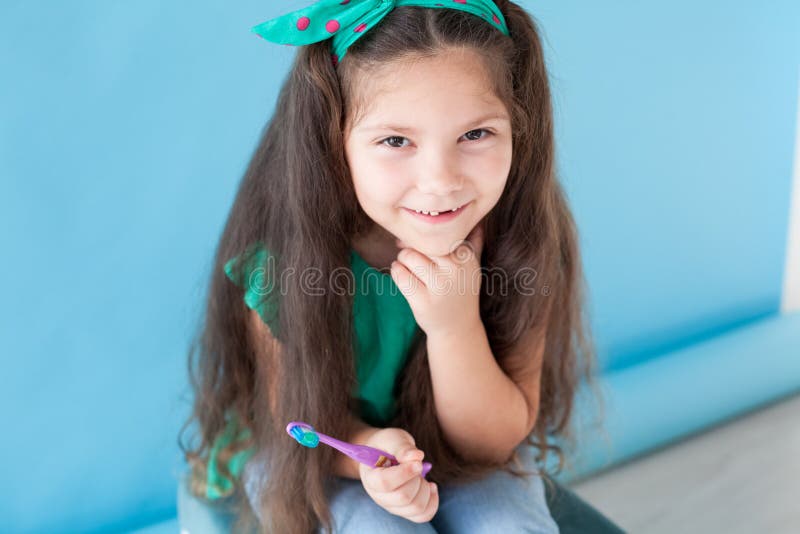 Bambina senza i denti con uno spazzolino da denti in odontoiatria fotografie stock libere da diritti Bambina senza i denti con uno spazzolino da denti in odontoiatria fotografie stock libere da diritti