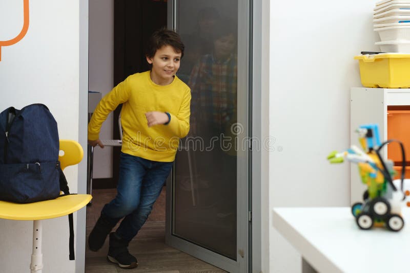 Children pupils running in school room on the brake. Happy kids having fun in elementary school. Modern education. Children pupils running in school room on the brake. Happy kids having fun in elementary school. Modern education