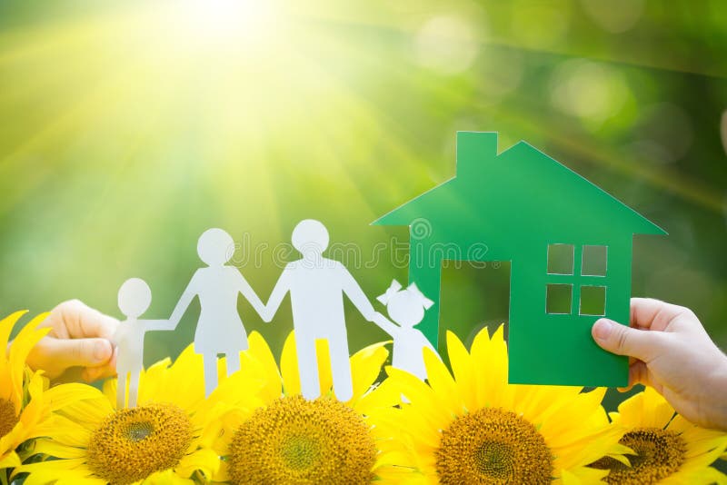 Children holding paper house and family in hands outdoors. Children holding paper house and family in hands outdoors