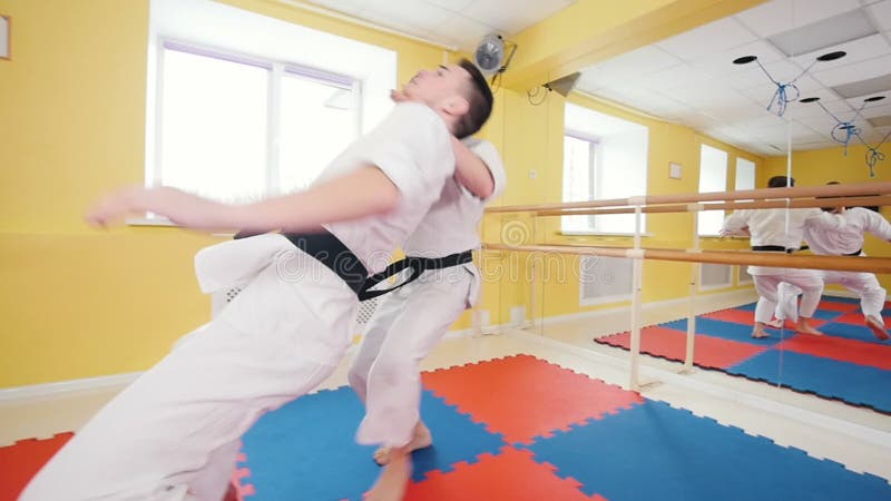 bambini cinesi di KONGFU Due uomini atletici che preparano le loro abilità di aikidi nello studio Schiva il colpo ed il lancio de