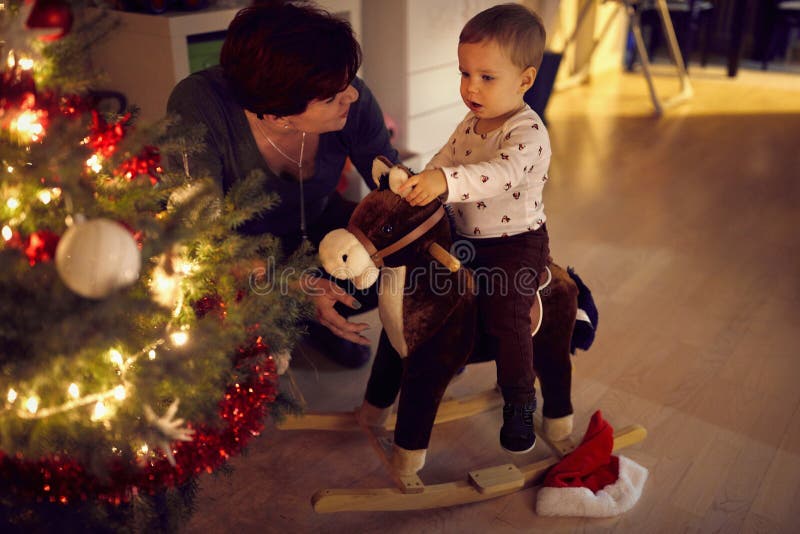 Bambini e mamma si divertono con un bellissimo albero di Natale decorato fotografia stock libera da diritti Bambini e mamma si divertono con un bellissimo albero di Natale decorato fotografia stock libera da diritti