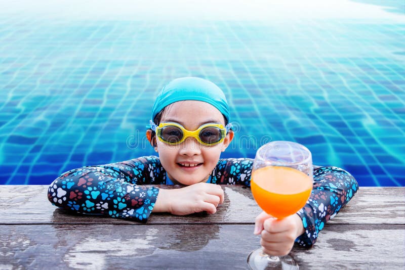 Bambini felici sul lato della piscina, ragazza che si rilassa con la somma immagine stock Bambini felici sul lato della piscina, ragazza che si rilassa con la somma immagine stock