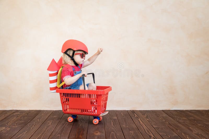 Bambino che gioca con il razzo del giocattolo a casa fotografie stock Bambino che gioca con il razzo del giocattolo a casa fotografie stock
