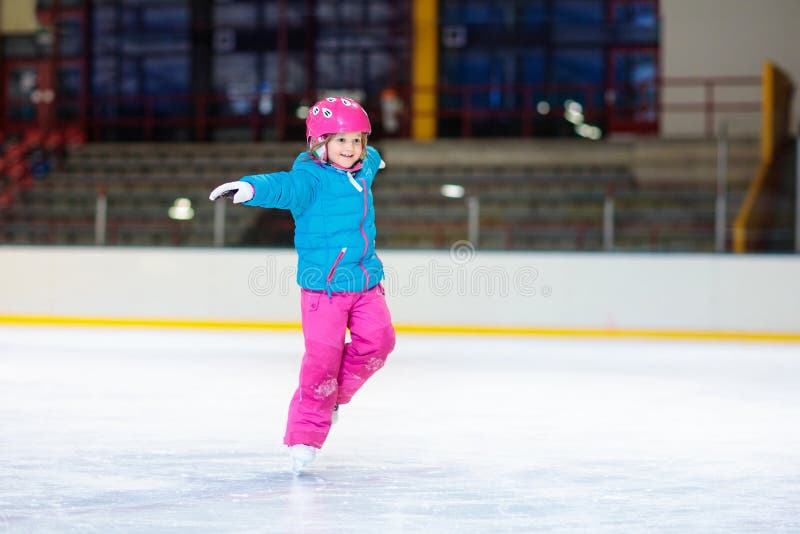Bambino che pattina sulla pista di pattinaggio sul ghiaccio dell'interno Pattino dei bambini