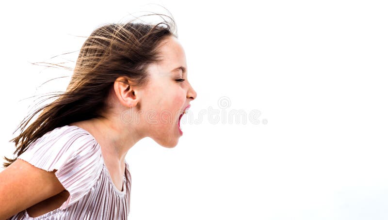 Little girl child yelling, shouting and screaming with bad manners. Angry upset girl is arguing with emotional expression on face. Frontal profile view of children. Isolated on white background. Little girl child yelling, shouting and screaming with bad manners. Angry upset girl is arguing with emotional expression on face. Frontal profile view of children. Isolated on white background