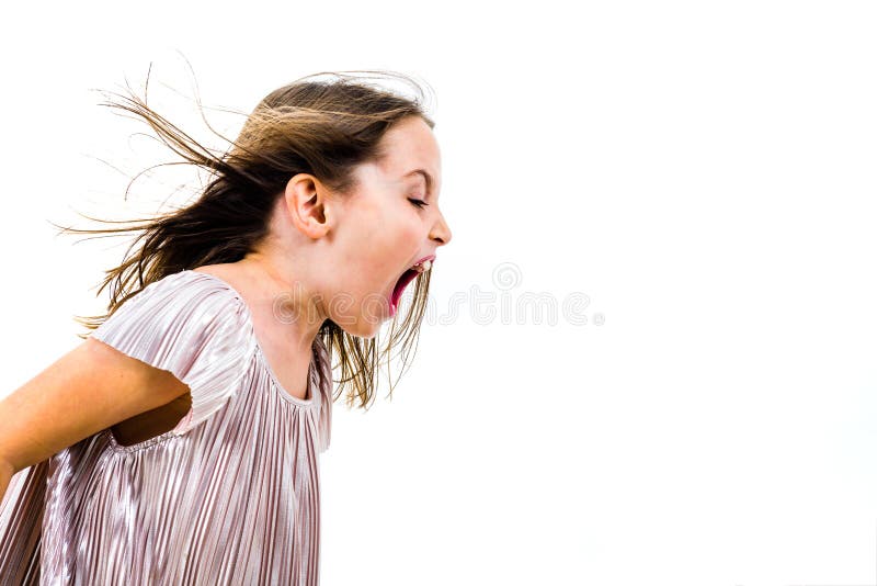 Little girl child yelling, shouting and screaming with bad manners. Angry upset girl is arguing with emotional expression on face. Frontal profile view of children. Isolated on white background. Little girl child yelling, shouting and screaming with bad manners. Angry upset girl is arguing with emotional expression on face. Frontal profile view of children. Isolated on white background