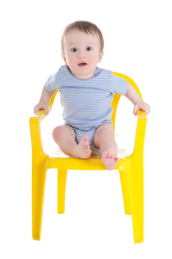 Bambino divertente del neonato che si siede su poca sedia isolata su bianco fotografia stock libera da diritti Bambino divertente del neonato che si siede su poca sedia isolata su bianco fotografia stock libera da diritti