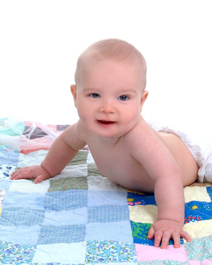 Cute baby lying in front of white background on a multicolored quilt. Cute baby lying in front of white background on a multicolored quilt