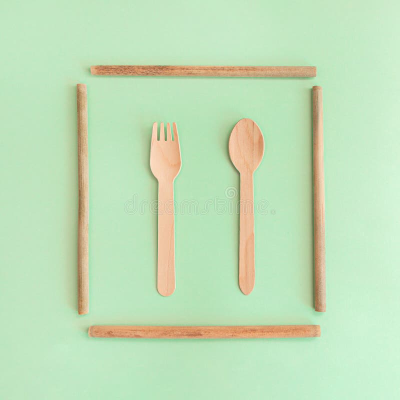 Bamboo Straws with Spoon and a Fork on the Mint Background. Stock Image