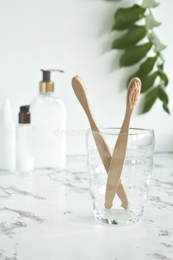 Bamboo Toothbrushes in a Glass Cup in the Bathroom Stock Photo Image