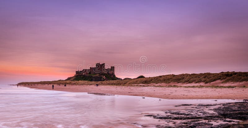 The Iconic Bamburgh Castle on the Northumberland Coastline in panorama at dusk. The Iconic Bamburgh Castle on the Northumberland Coastline in panorama at dusk