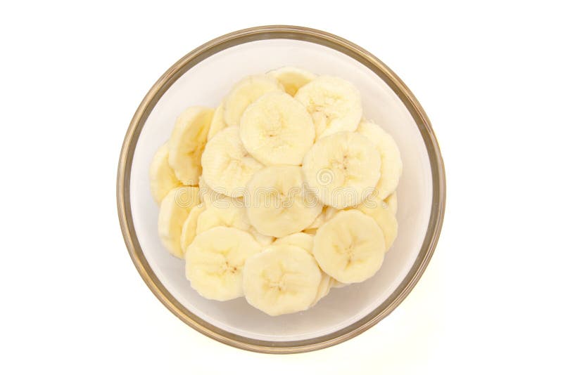 Banana slices on bowl on white background viewed from above. Banana slices on bowl on white background viewed from above