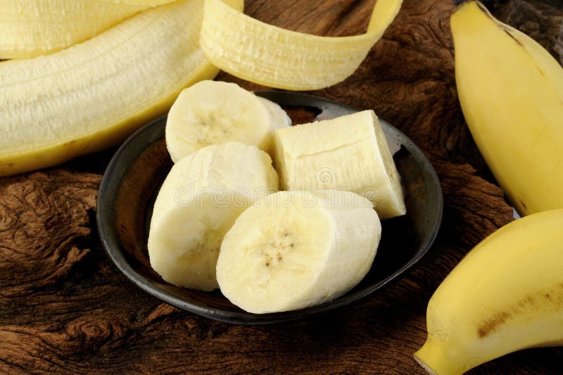 Banana cortada na bacia em de madeira foto de stock royalty free Banana cortada na bacia em de madeira foto de stock royalty free