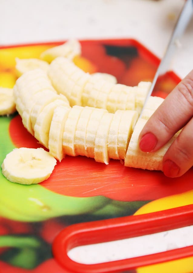 Raw Banana Cut With Knife In Hand On Wood Table. Stock Image Image of