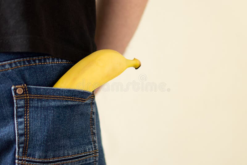 Banana in the back pocket stock photo. Image of contraception 155672518
