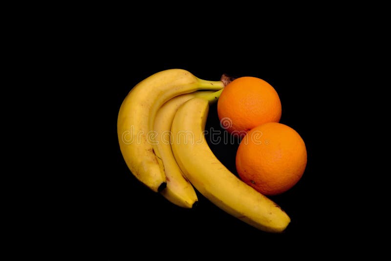 Bananas And Oranges Lie On A Black Tropical Fruit Stock Photo Image