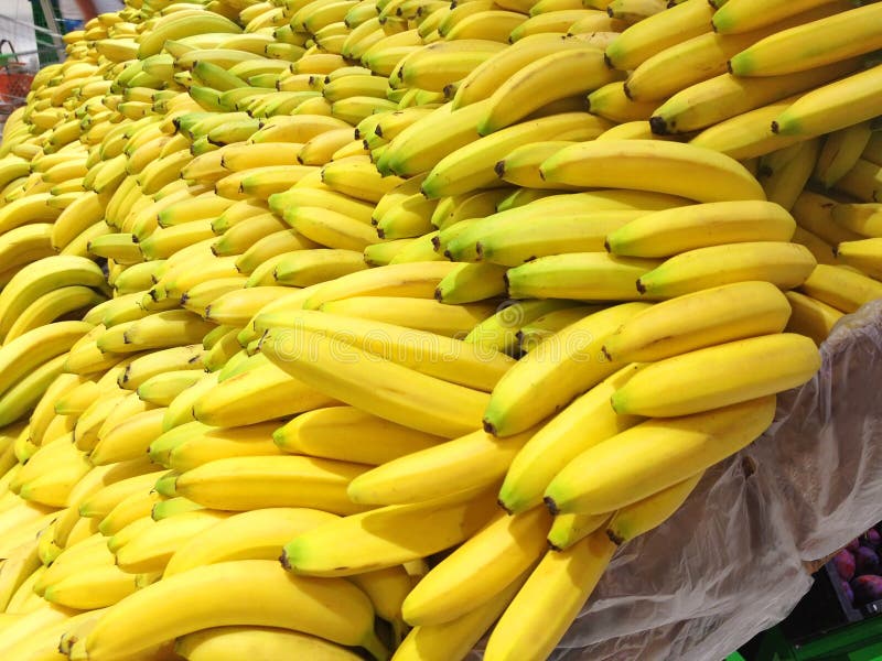 Many fresh bananas lying in boxes in supermarket. Many fresh bananas lying in boxes in supermarket