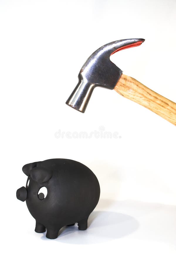 Piggy bank with hammer about to smash it. Piggy bank with hammer about to smash it.