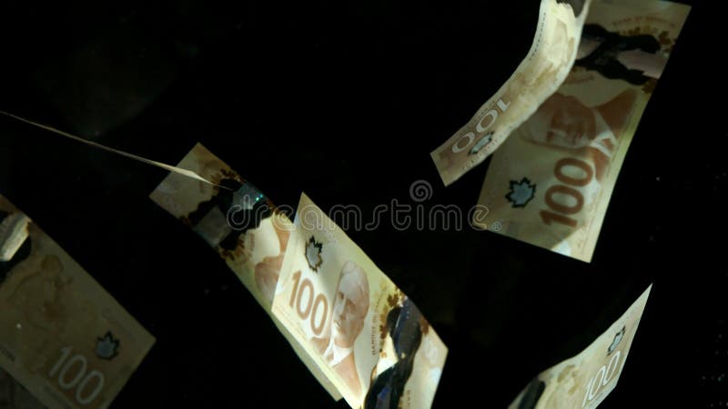 Banconote in dollari canadesi americane in caduta volante su sfondo nero. banconote in dollari di qualità elevata